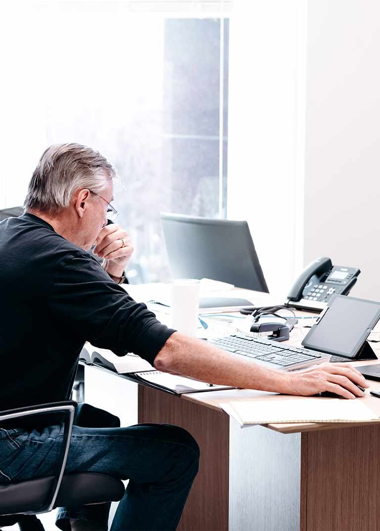 a man focusing while on the computer